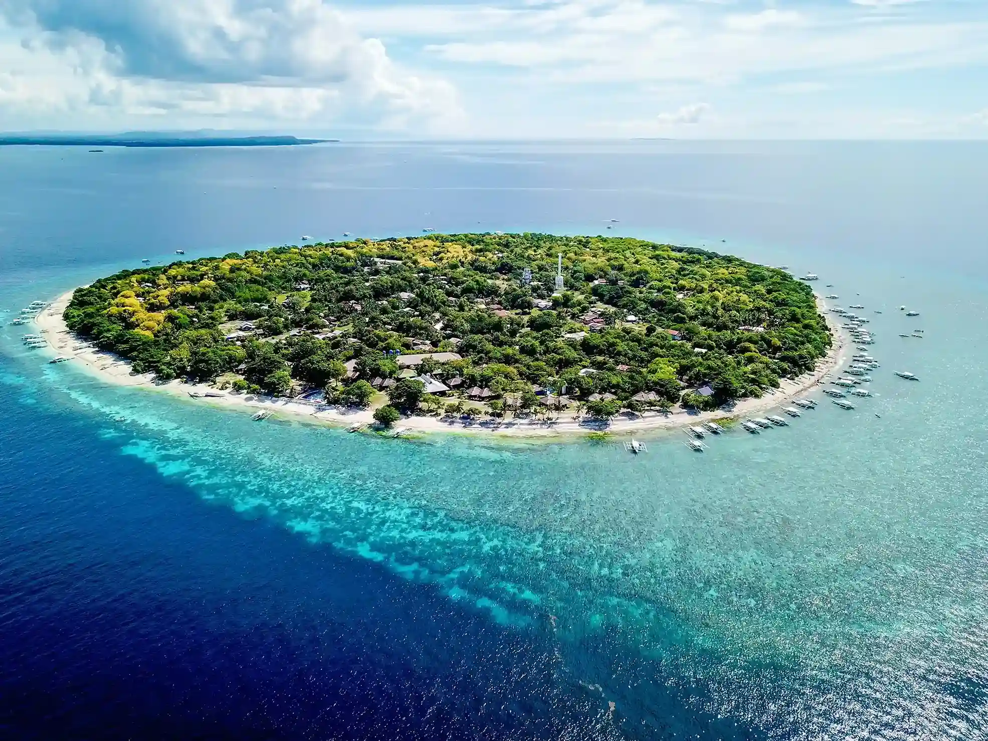 Aerial view of Balicasag Island ringed by reef and turquoise sea near Bohol