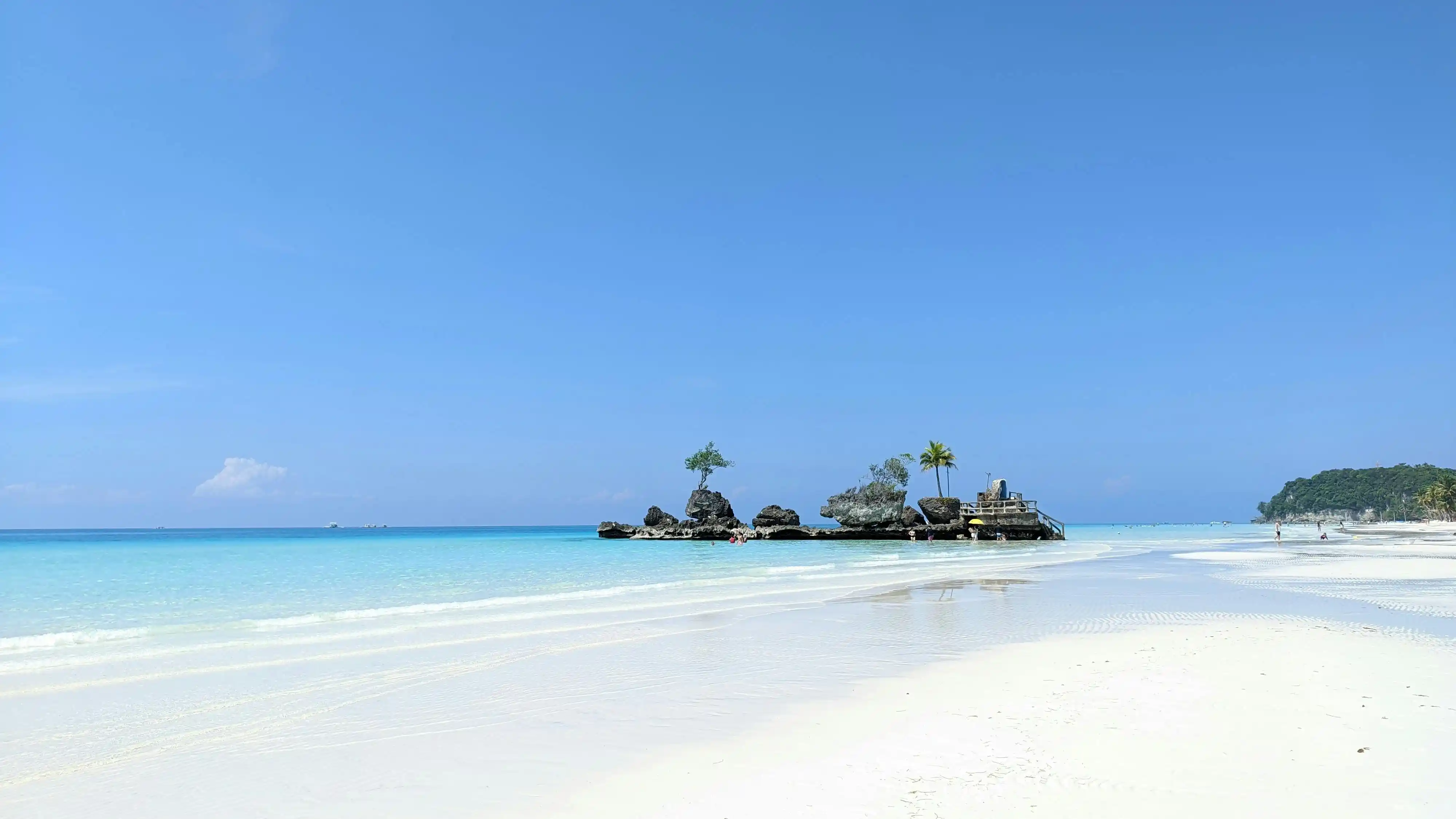 Willy's Rock standing in shallow water off White Beach, Boracay