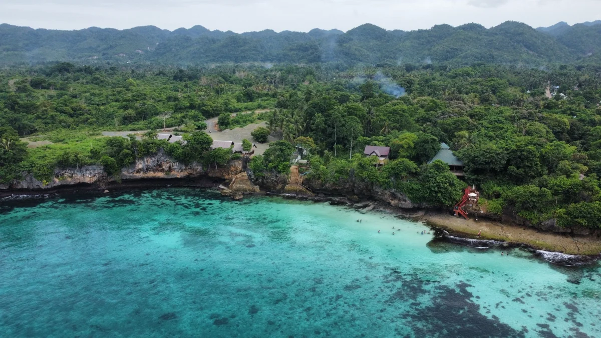 A secluded turquoise cove enclosed by limestone cliffs near Coron, Palawan