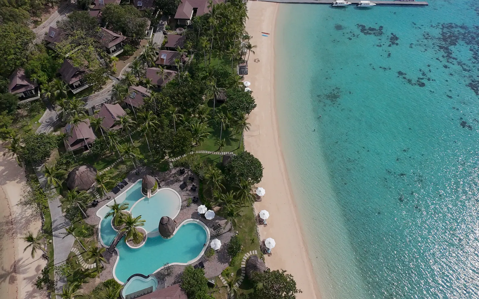 Overwater walkway leading to a luxury island resort in the Philippines