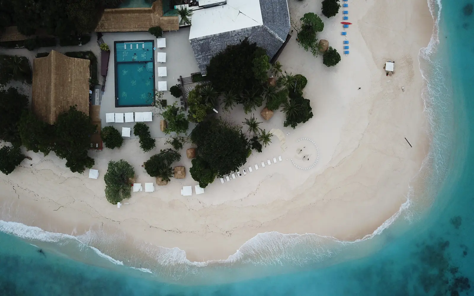 Infinity pool overlooking a turquoise bay at a Philippine luxury resort