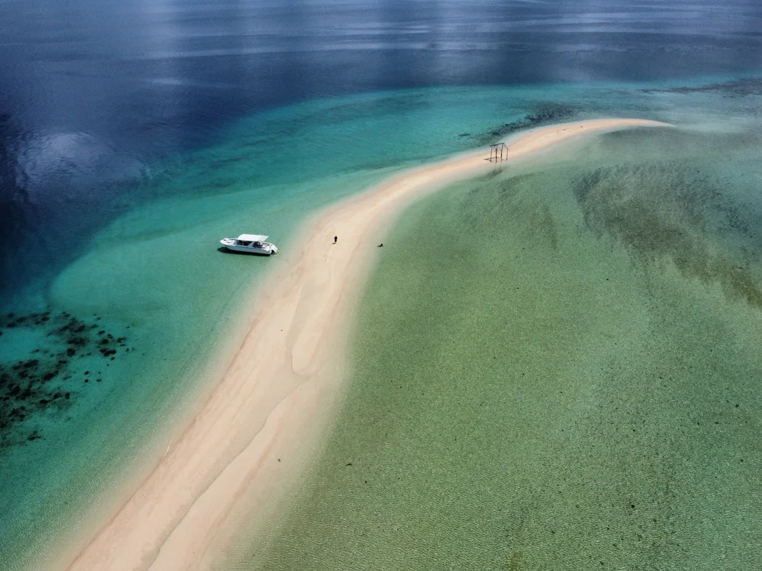 A bright sandbar surrounded by shallow turquoise water